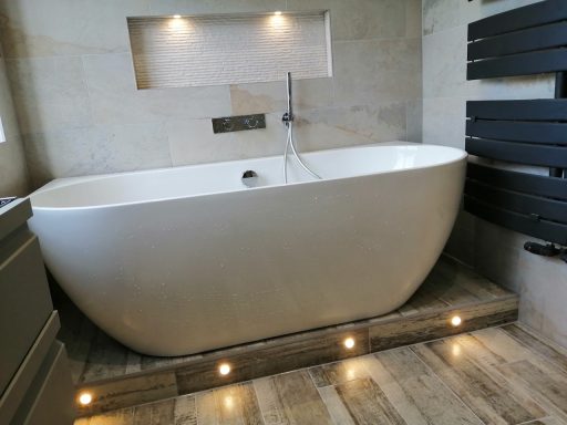 Freestanding bath in Wimbledon Modern bathroom featuring a freestanding white bathtub installation in Wimbledon by Tom's Services
